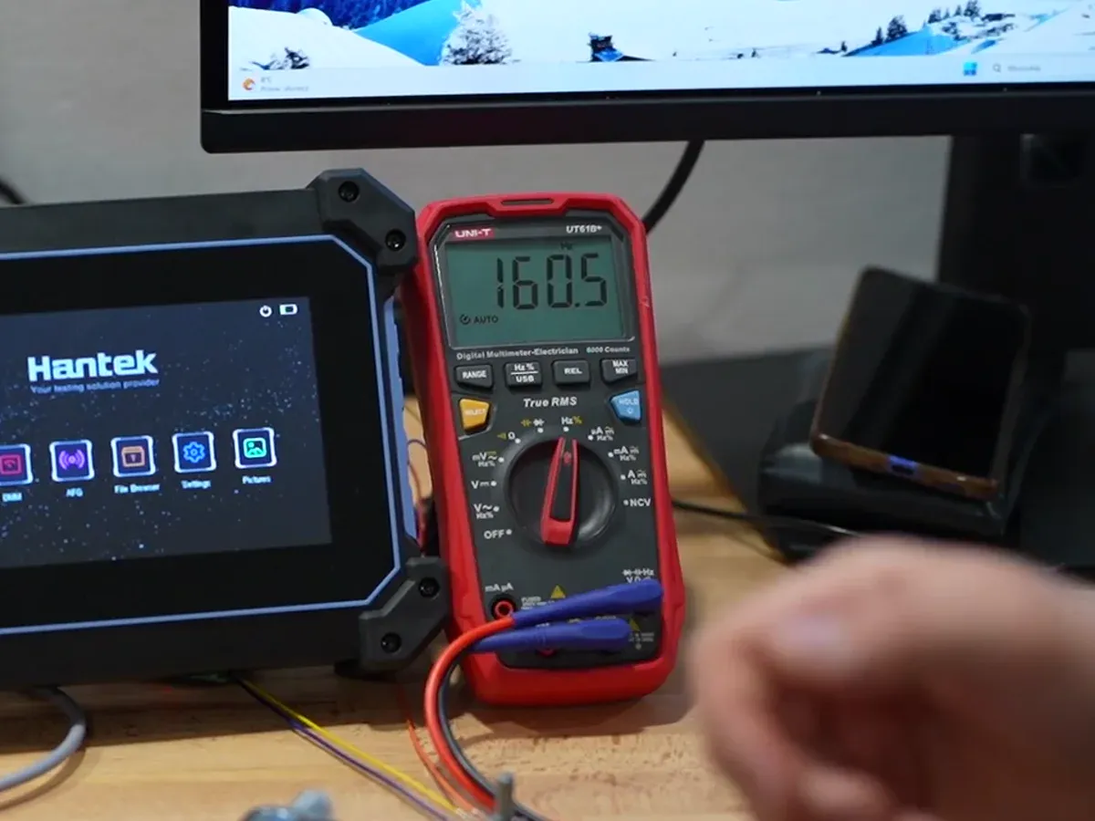 Multimeter in Hz mode: 160.5 Hz